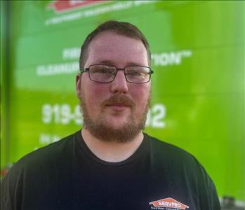 Man standing in front of a green SERVPRO background.